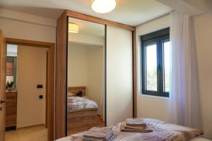 a bedroom with a mirror and a bed at Casa Oliva Tivat in Tivat