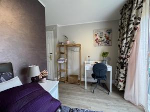 a bedroom with a bed and a desk with a chair at Chrysanthemum Drive stays in Shinfield