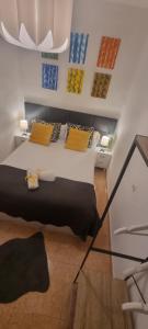 a bedroom with a bed with yellow pillows on it at Casa Roman SPORT in León