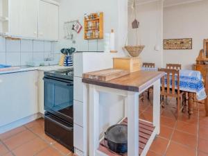 a kitchen with a table in the middle of it at Kusweg Oos 1 in Struisbaai