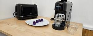 a coffee maker sitting on a table next to a blender at Studio Cozy Paris & Disneyland in Bry-sur-Marne