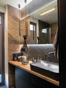 a bathroom with a sink and a mirror at Ostoja Dębowa Studnica in Studnica +52 photos