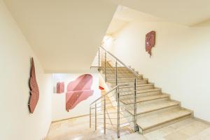 a staircase in a white room with a stair railing at Hotel Alexander in Krakow