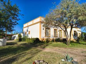 an old house with a tree in front of it at Finca La Penúltima-Posada in San Rafael
