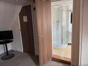 a bathroom with a shower and a glass door at Sams Wine Bar Harwich ltd in Harwich +84 photos