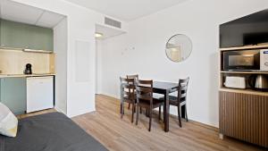 a kitchen and dining room with a table and chairs at Virginia N302 - 2p4 in Grasse