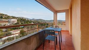 a balcony with a blue table and two chairs at Virginia N302 - 2p4 in Grasse