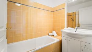 a bathroom with a bath tub and a sink at Virginia N302 - 2p4 in Grasse +4 photos