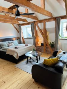 a bedroom with a bed and a couch and a table at FOUR ROOMS Carlsbad Authentic in Karlovy Vary