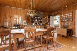 a dining room with a large wooden table and chairs at Nedre Berg Gard in Lillehammer +16 photos