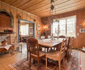 a dining room with a wooden table and chairs at Nedre Berg Gard in Lillehammer
