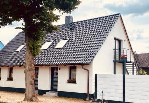 a white house with a black roof at Sonnenhof Krausnick in Krausnick