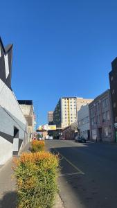an empty street in a city with tall buildings at 201 On Main in Johannesburg