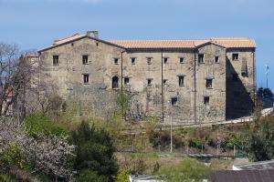 a large stone building on top of a hill at MaMo B&B in Nocera Terinese