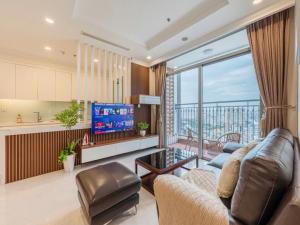 a living room with a couch and a television at Landmark City View - Apartment in Ho Chi Minh City