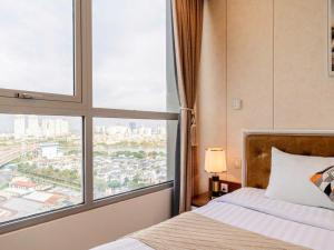 a bedroom with a bed and a large window at Landmark City View - Apartment in Ho Chi Minh City