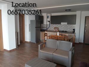 a kitchen and dining room with a table and chairs at Maya location in Bejaïa