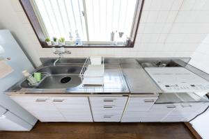 a small kitchen with a sink and a window at Coto House Kamakura RoomA in Kamakura +133 photos