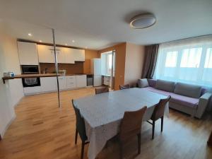 a living room with a table and a couch at VP Apartment Sillamäe in Sillamäe