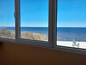 an open window with a view of the ocean at VP Apartment Sillamäe in Sillamäe