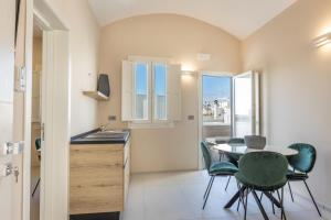 a kitchen and dining room with a table and chairs at Dimora Suite Idro in Gallipoli