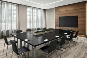 a conference room with a black table and chairs at AC Hotel by Marriott Ann Arbor Downtown in Ann Arbor