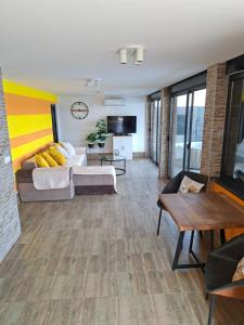 a living room with a couch and a table at Sap Pool House in Ritopek