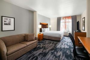 a hotel room with a bed and a couch at Fairfield Inn & Suites by Marriott Denver Aurora/Parker in Foxfield