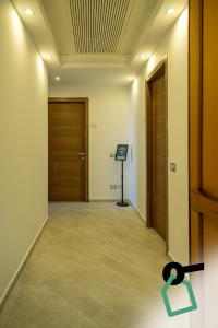 a hallway with a door and a sign on the wall at Hotiday Gallipoli Lungomare in Gallipoli