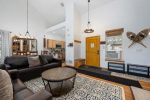 a living room with a couch and a table at 100 Fairway Lane in Granby