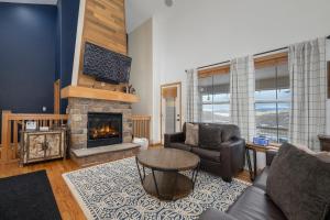 a living room with a couch and a fireplace at 100 Fairway Lane in Granby