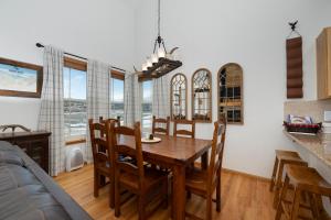 a kitchen and dining room with a wooden table and chairs at 100 Fairway Lane in Granby