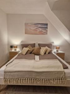 a bedroom with a large bed with two lamps at Daheim in Burk in Burk