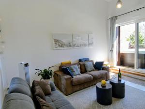 a living room with two couches and a large window at Appartement 3 chambres - 100m2 - Jacuzzi in Les Deux Alpes
