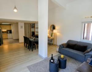 a living room with a couch and a dining room at Appartement 3 chambres - 100m2 - Jacuzzi in Les Deux Alpes