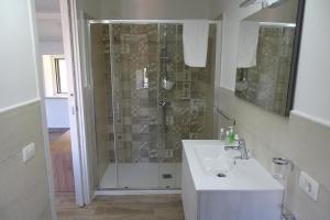 a bathroom with a shower and a white sink at MaMo B&B in Nocera Terinese +34 photos