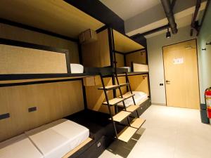 a room with two bunk beds and a door at Maya Hostel El Nido in El Nido +24 photos