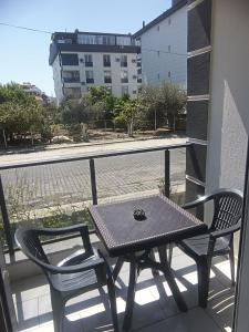 a table and two chairs on a balcony at YoYo Apart in Dalaman