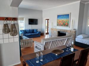 a living room with a table and a couch at EBB Tide Guesthouse in Velddrif