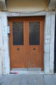 a large wooden door with a number on it at Dorso Duro Apartment in Venice