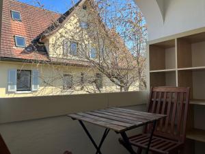 a wooden bench sitting on a balcony with a building at 1 bed flat in central Zug in Zug +2 photos