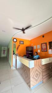 a man sitting at a counter in a room at Gravity Groups VHR Residency - near santho lawns in Pondicherry