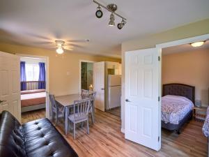 a living room with a couch and a table at Four Seasons Algonquin Cabins in Madawaska