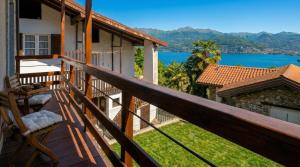 a balcony of a house with a view of the water at Ca da Smarè - Where Time stands Still in Someraro