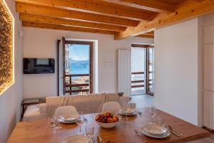 a dining room with a table with a bowl of fruit at Ca da Smarè - Where Time stands Still in Someraro