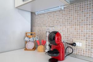 a kitchen counter with a red mixer on a counter top at Case D'Amare - Tritone 30 in Polignano a Mare