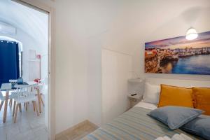 a bedroom with a bed and a table in a room at Case D'Amare - Tritone 30 in Polignano a Mare