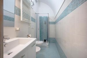 a bathroom with a tub and a toilet and a sink at Case D'Amare - Tritone 30 in Polignano a Mare +12 photos