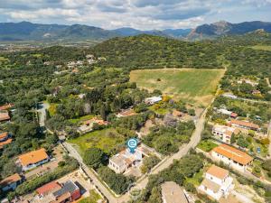 an aerial view of a small town with houses and mountains at Estay - Casa Madili - Garden - BBQ - WiFi in Sarroch