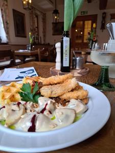 a plate of food on a table with a plate of food at Hotel Bezold in Rothenburg ob der Tauber